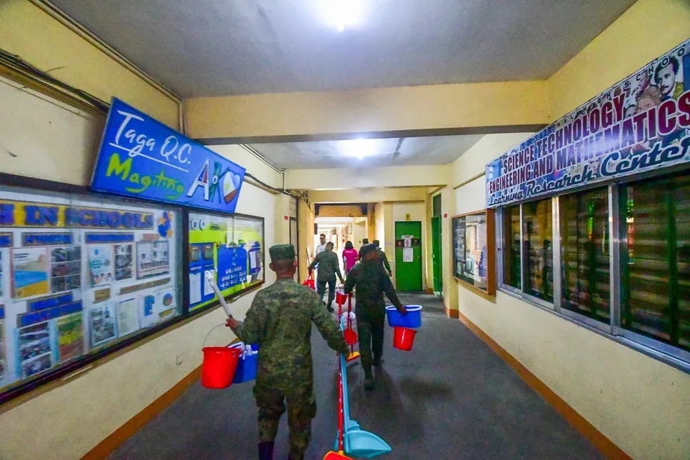 Volunteers inspect and clean the facilities of Batasan Hills National High School in Quezon City on July 1, 2024, as part of the Department of Education's Brigada Eskwela 2024 Regional Pre Kick-Off.