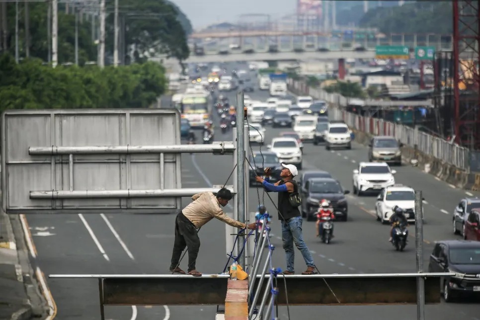 Workers do metal works at a waiting shed being constructed along Commonwealth Avenue in Quezon City on August 26, 2024 as the country celebrates National Heroes Day.