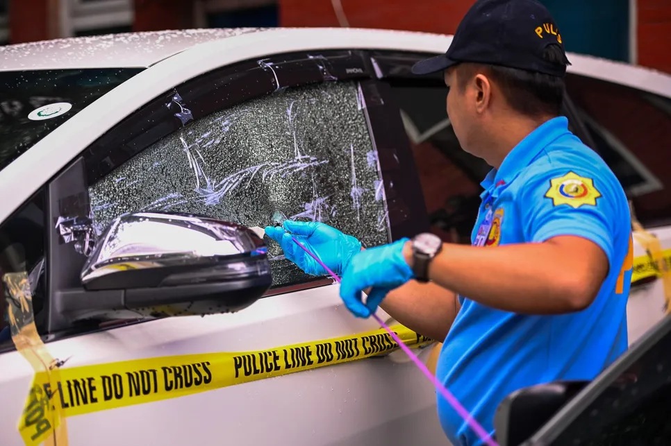 Scene of Crime Operation (SOCO) personnel conduct a bullet trajectory examination on the vehicle driven by Aniceto Mateo, a 65-year-old driver who died in a shooting incident while traversing the Ayala tunnel in Makati, on May 29, a day after the shooting. 
