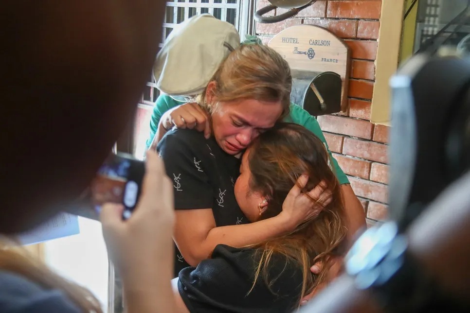 Angelica P. Yulo, mother of two-time Paris Olympics gold medalist Carlos Yulo, turns emotional as she hugs her husband, Mark Andrew, and daughter, Joriegel, shortly after a press briefing at the Heroes Hotel in Manila on August 7, 2024.
Jonathan Cellona, ABS-CBN News