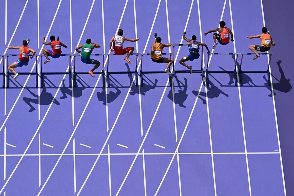 An overview shows (fromL) Chile's Martin Saenz De Santa Maria, Philippines' John Cabang, Brazil's Eduardo Rodrigues, Poland's Jakub Szymanski, Germany's Manuel Mordi, France's Raphael Mohamed, Japan's Rachid Muratake and Spain's Enrique Llopis competing in the men's 110m hurdles heat of the athletics event at the Paris 2024 Olympic Games at Stade de France in Saint-Denis, north of Paris, on August 4, 2024. Antonin Thuillier, AFP 