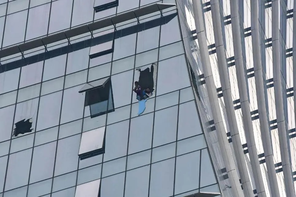 People break glass windows during SM Mega Tower fire
