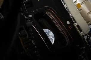 This handout picture provided by NASA shows a view of Earth taken by NASA astronaut and Artemis II commander Reid Wiseman from one of the Orion spacecraft's four main windows after completing the translunar injection burn on April 2, 2026. Reid Wiseman, NASA via AFP