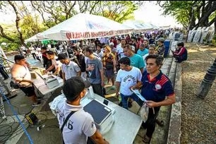 Around 8,000 Transport Network Vehicle Services (TNVS) drivers line up inside the covered court at the Quezon Memorial Circle in Quezon City on March 24, 2026, to avail themselves of the government's cash assistance program. The program targets public transport groups affected by massive fuel hikes stemming from the ongoing conflict in the Middle East.  Maria Tan, ABS-CBN News