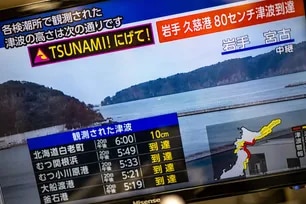 This photo shows a warning message on a screen from a live feed on NHK with tsunami alert after an earthquake hit northern Japan, in Tokyo on April 20, 2026. Philip Fong, AFP