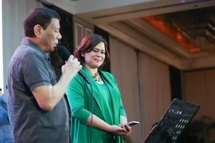 President Rodrigo Roa Duterte performs a duet with his daughter, Davao City Mayor Sara Duterte-Carpio, during the Hugpong ng Pagbabago (HNP) Thanksgiving Night at the Peninsula Manila in Makati City on June 24, 2019. Karl Norman Alonzo, Presidential Photo