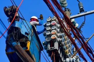 Workers inspect an electric meter installed above ground in Manila on January 11, 2024. Mark Demayo, ABS-CBN News