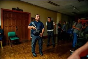 Members of the Office of the Sergeant-at-Arms of the Philippine Senate ask members of the press to leave the Senate hall after consecutive gunshots were heard on the evening of May 13, 2026. Maria Tan, ABS-CBN News