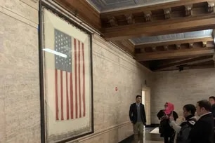 Visitors view the Peace Flag — a US flag bordered in white to represent an alternative to militant patriotism — at the Christian Science Plaza in Boston, Massachusetts. Jonathan de Santos, ABS-CBN News, file