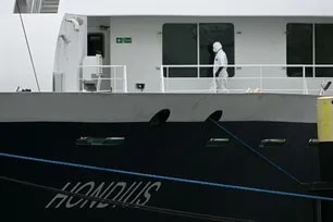 A person wearing a protective suit walks aboard the Dutch Hantavirus-hit cruise ship MV Hondius after arriving at the port of Rotterdam on May 18, 2026. Nicolas Tucat, AFP