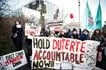 Protestors, rallying in support of the detention of former Philippine's president Rodrigo Duterte, hold a placard which reads as "Hold Duterte accountable now" outside of the International Criminal Court (ICC) where he will be questioned by the International Criminal Court on charges of crimes against humanity, in The Hague on February 23, 2026. Simon Wohlfahrt, AFP