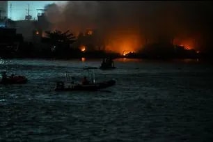 Members of the Philippine Coast Guard continue to monitor the ongoing fire in Brgy. Parola as firefighting operations remain underway, May 23, 2026. Maria Tan, ABS-CBN News
