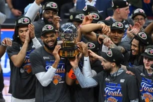 Karl-Anthony Towns of the New York Knicks celebrates with the Bob Cousy Trophy after defeating the Cleveland Cavaliers in Game 4 of the NBA Eastern Conference Finals at Rocket Arena in Cleveland, Ohio. Jason Miller, Getty Images via AFP