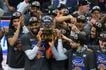 Karl-Anthony Towns of the New York Knicks celebrates with the Bob Cousy Trophy after defeating the Cleveland Cavaliers in Game 4 of the NBA Eastern Conference Finals at Rocket Arena in Cleveland, Ohio. Jason Miller, Getty Images via AFP