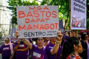 Women leaders from World March of Women – Pilipinas, dressed in purple and as babaylans, carry a symbolic jail and push standees of alleged perpetrators of corruption during a protest march from the Philippine Children’s Medical Center to the Office of the Ombudsman on Friday, March 6, ahead of International Women’s Day. Maria Tan, ABS-CBN News