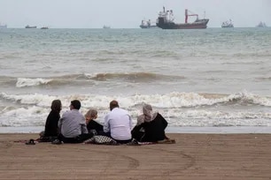 In this picture obtained from Iran's ISNA news agency on April 24, 2026, Iranians are seen at Suru Beach in Bandar Abbas along the Strait of Hormuz. Razieh Poudat, ISNA via AFP