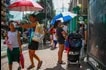 Guardians use sun protection against the hot weather as they fetch their children from a public school along Pedro Gil Street way in Manila on May 3, 2023. Jonathan Cellona, ABS-CBN News/File