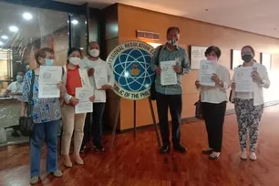Members of the Alliance of Health Workers with Atty. Antonio La Viña of Movement Against Disinformation file a complaint against Lorraine Badoy-Partosa in April 2022. Alliance of Health Workers Facebook page