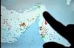 A person points at a page on the Marinetraffic website that shows commercial boats traffic on the edge of the Strait of Hormuz near the Iranian coast, in Paris on March 4, 2026. Photo by Julien De Rosa/AFP