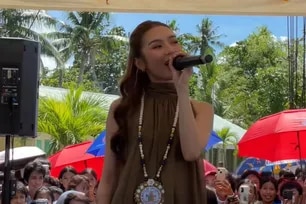 Francine Diaz performs at Tacloban school two weeks after deadly shooting