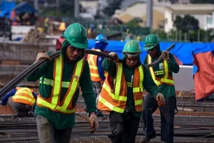 Workers traverse the expanse in between concrete columns as they go about their work. Mark Demayo, ABS-CBN News