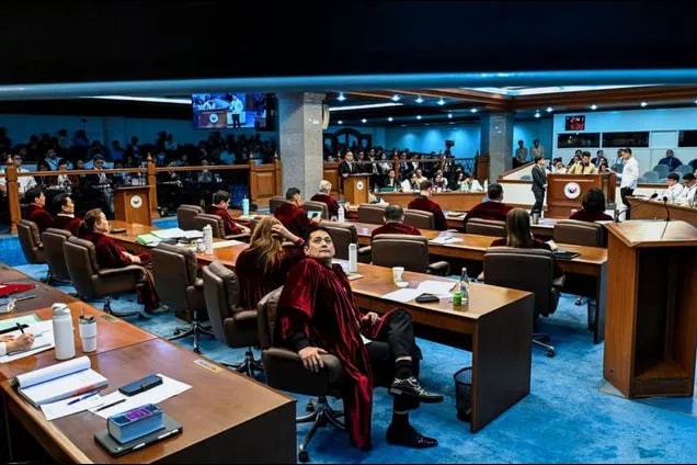 The Senate of the Philippines sits as an impeachment court for the third day of the trial against Vice President Sara Duterte on July 8, 2026. Defense counsel Atty. Carlo Joaquin Narvasa cross-examined National Bureau of Investigation (NBI) Agent John Mark Calilung, who analyzed the November 23, 2024 video where the Vice President allegedly made death threats against President Ferdinand Marcos Jr., First Lady Liza Araneta-Marcos, and former House Speaker Martin Romualdez. Maria Tan, ABS-CBN News