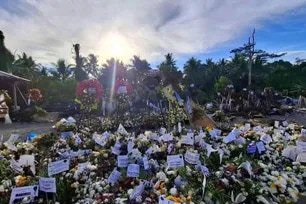 Rene Baterbonia's tomb filled with flowers as people remember him 1 month after death