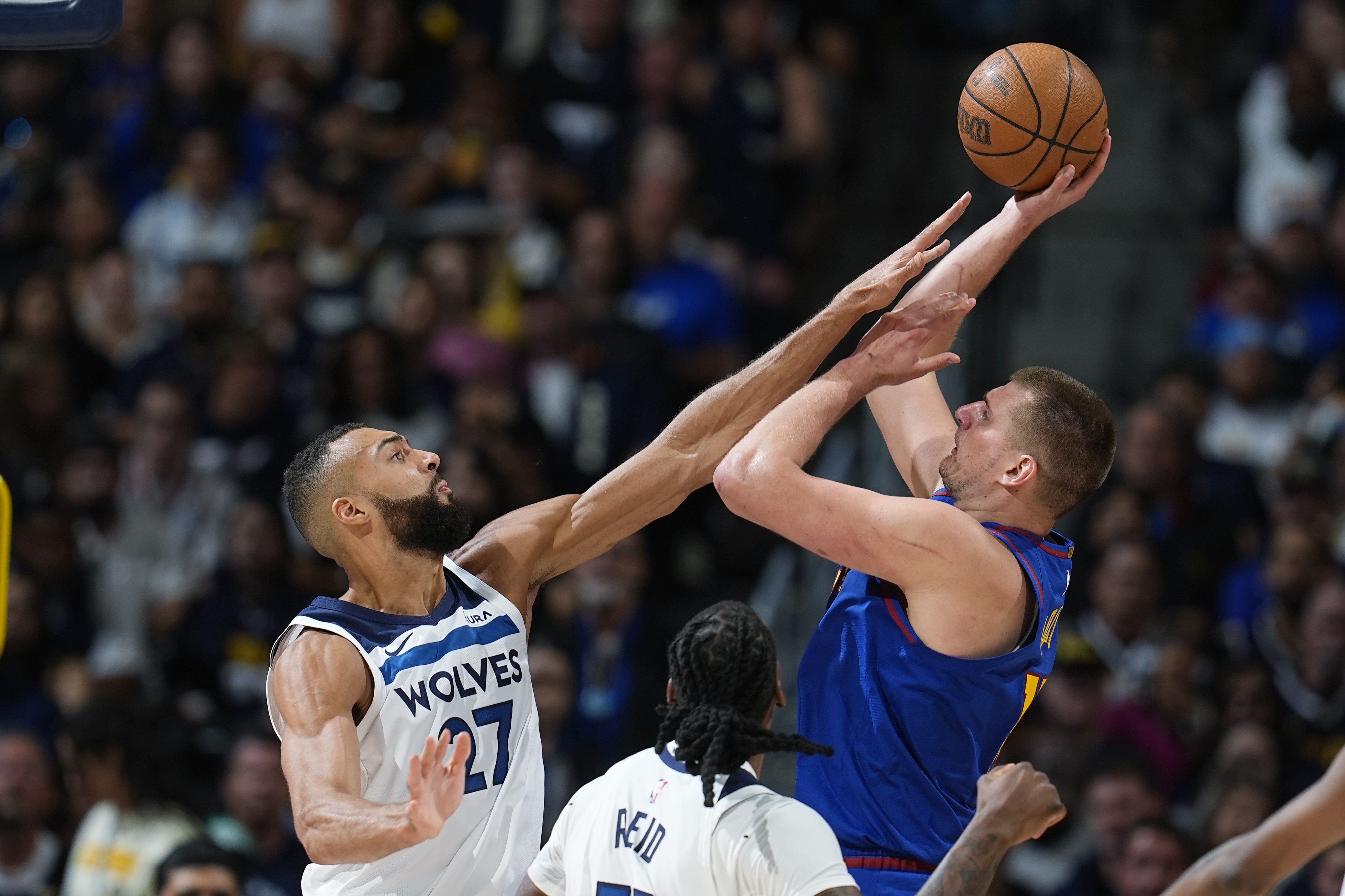 Minnesota Timberwolves center Rudy Gobert, left, goes up to block a shot by Denver Nuggets center Nikola Jokic, right, as Timberwolves center Naz Reid (11) looks on in the second half of Game 1 of an NBA basketball second-round playoff series Saturday, May 4, 2024, in Denver. David Zalubowski, AP Photo