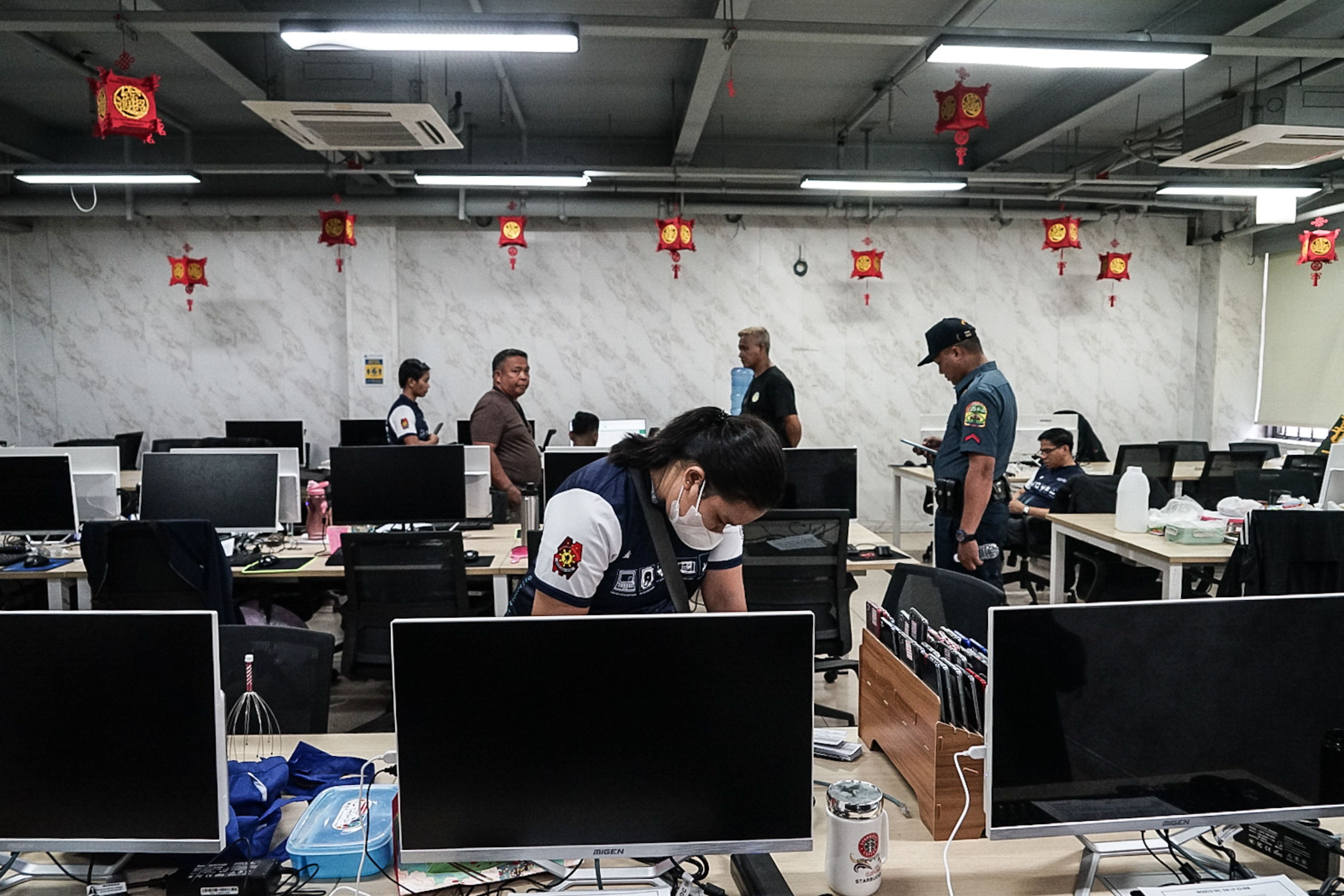 Operatives of PNP Anti-Cybercrime Group process seized computers and cellphones used for alleged illegal Philippine Offshore Gaming operation in Almanza Uno in Las Pinas City on June 27, 2023. File