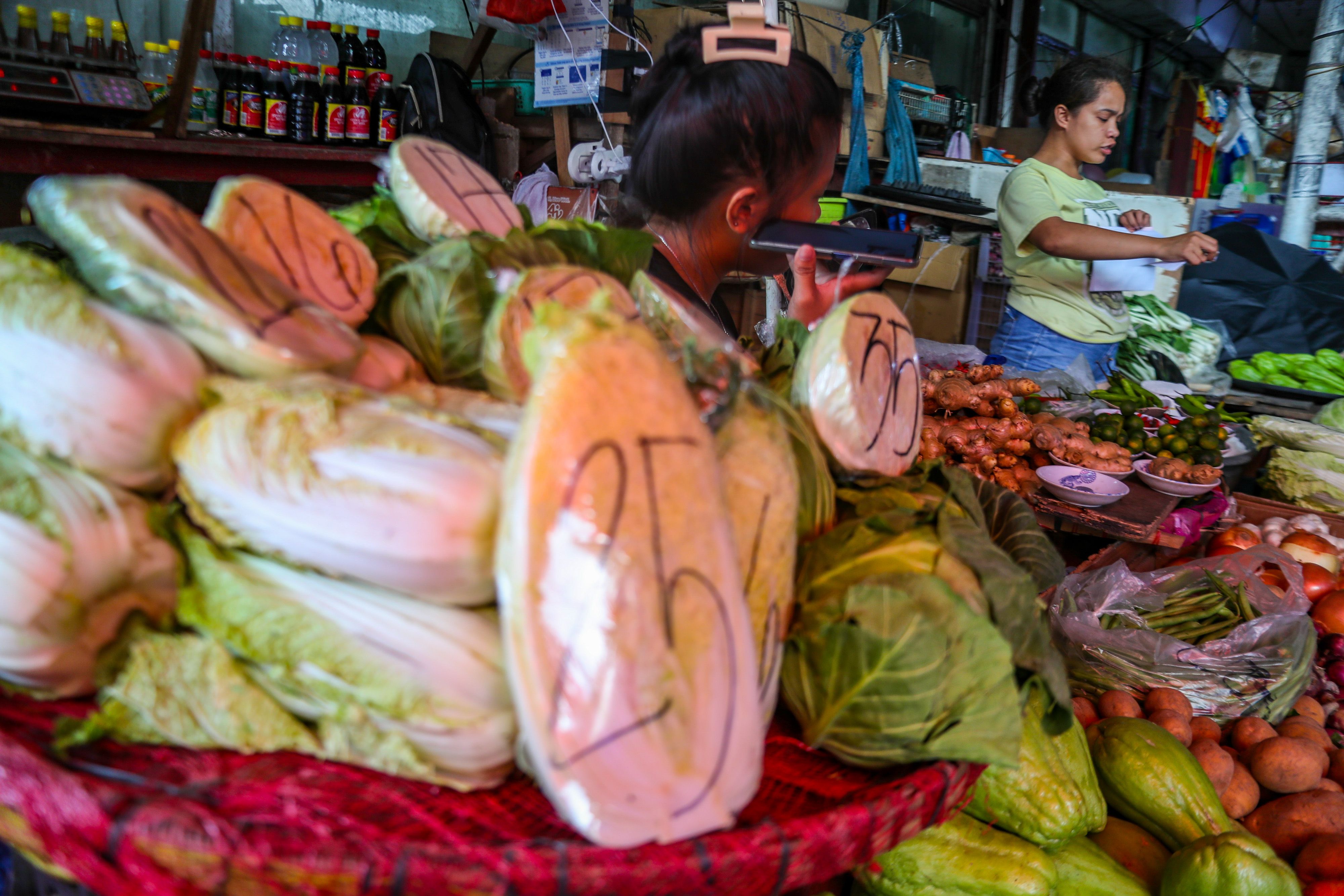 A vegetable vendor puts the current price of the produce on the plastic covers at the Kamuning Market in Quezon City on January 5, 2024. Jonathan Cellona, ABS-CBN News/FileA vegetable vendor puts the current price of the produce on the plastic covers at the Kamuning Market in Quezon City on January 5, 2024. Jonathan Cellona, ABS-CBN News/File