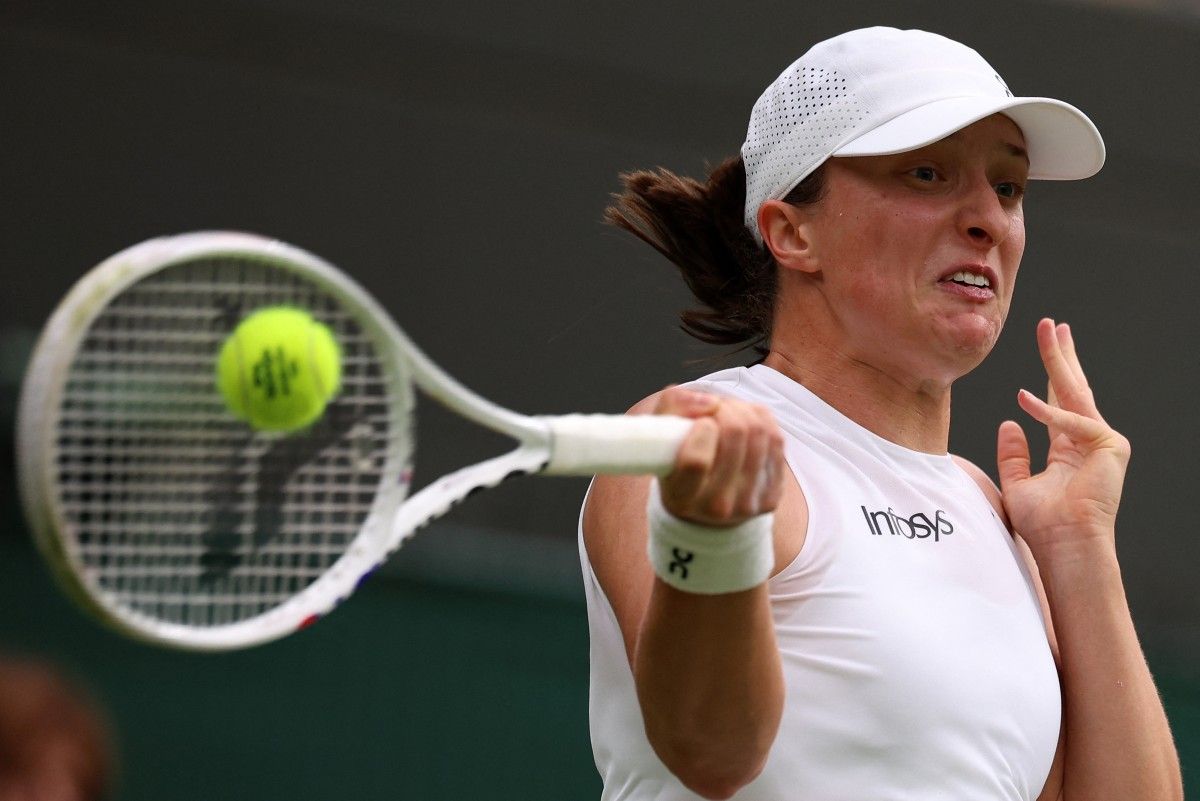 Poland's Iga Swiatek returns against Kazakhstan's Yulia Putintseva during their women's singles tennis match on the sixth day of the 2024 Wimbledon Championships at The All England Lawn Tennis and Croquet Club in Wimbledon, southwest London, on July 6, 2024. Henry Nicholls, AFP