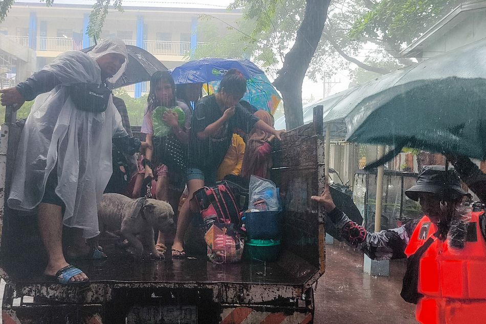 Members of the Brgy. Jesus Dela Peña DRRMO rescue residents in Provident Village in Marikina City amid floods due to rainfall brought by the southwest monsoon, enhanced by Typhoon Carina, on July 24, 2024. Mark Demayo, ABS-CBN News