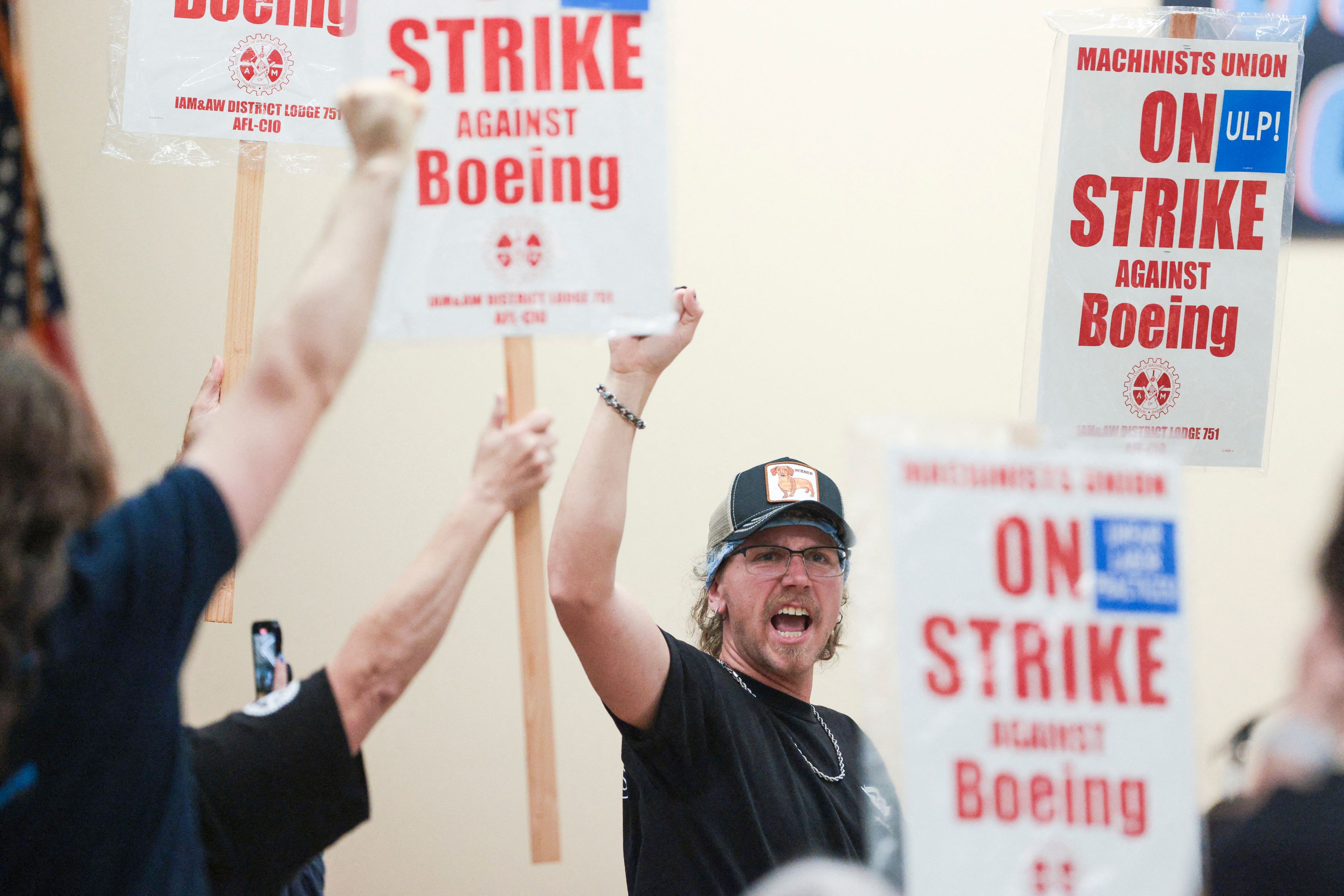 Union members react as Aerospace Machinists District 751 President Jon Holden (out of frame) announces that union members rejected a proposed Boeing contract and will go on strike, following voting results at their union hall in Seattle, Washington, on September 12, 2024. Jason Redmond, AFP