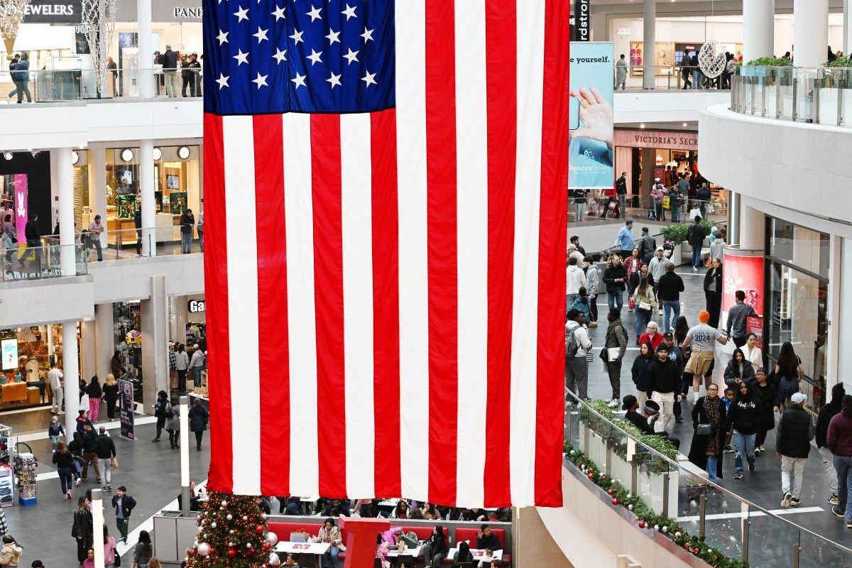 Customers looking for deals walk in a mall on Black Friday in Arlington, Virginia on November 29, 2024. The annual Black Friday shopping day has always been about finding the best deals, but this year retailers are preparing for a US consumer more zealously fixated than ever on getting value for their money. Roberto Schmidt, AFP