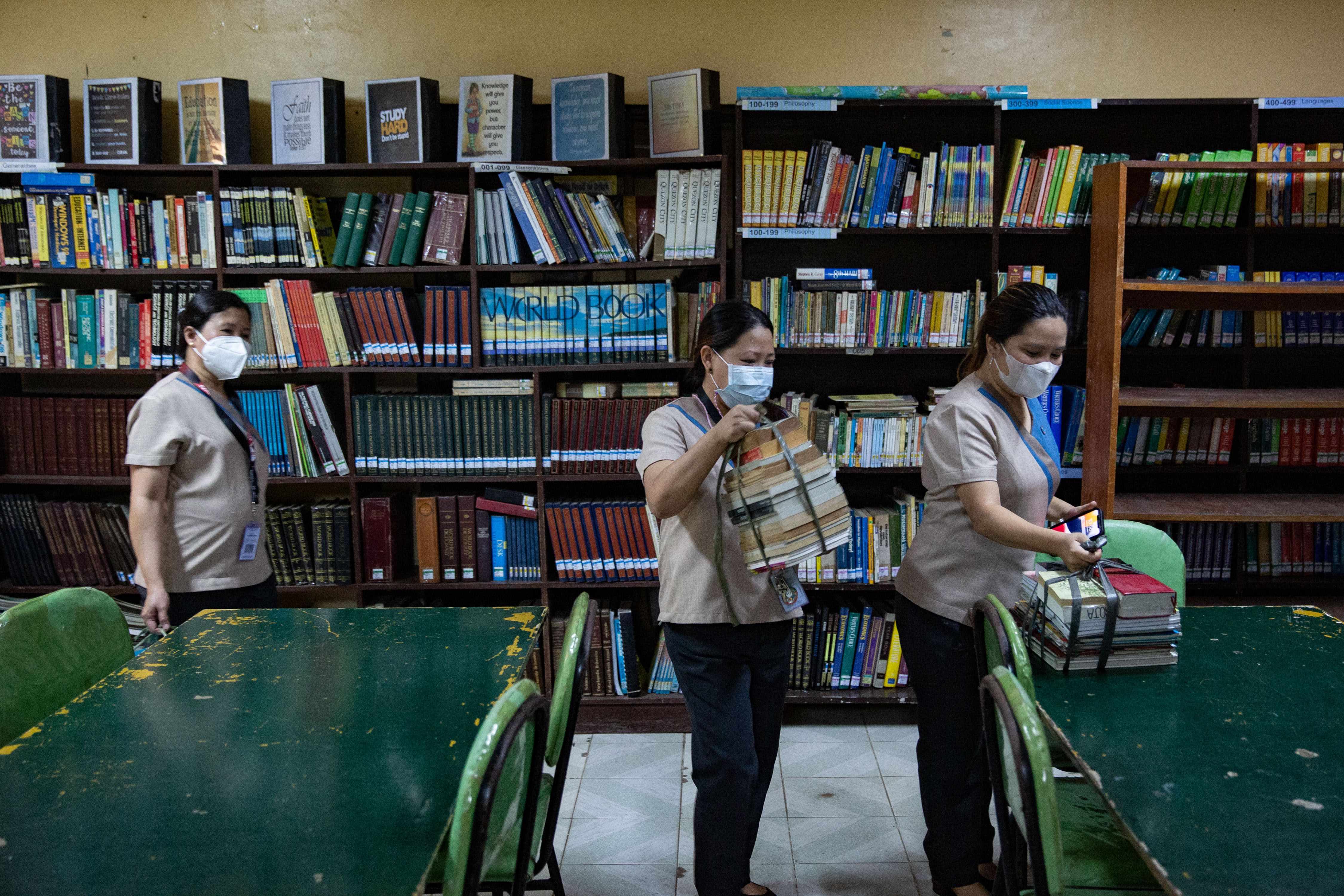 Teachers gather books donated as the Alliance of Concerned Teachers (ACT) launched Tulong Guro donation drive and relief operations to assist teachers and learners in Sta. Lucia Highschool in Quezon City on September 27, 2022. George Calvelo, ABS-CBN News/File
