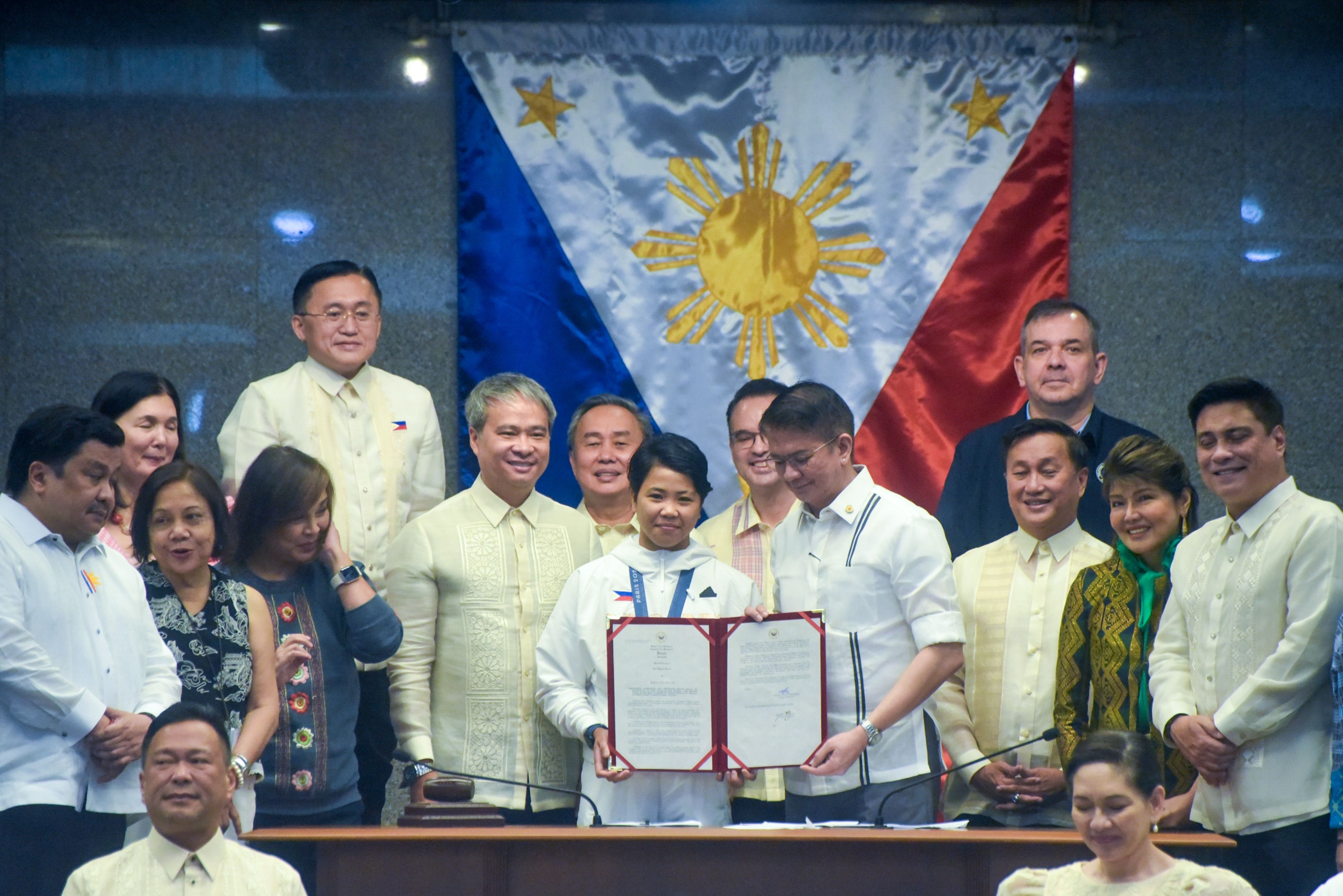 Bronze medalist at the 2024 Paris Olympic Games, Aira Villegas, receives her award and cash incentive from the Senate during the plenary session in Pasay City on August 19, 2024. Mark Demayo, Senate Pool/File