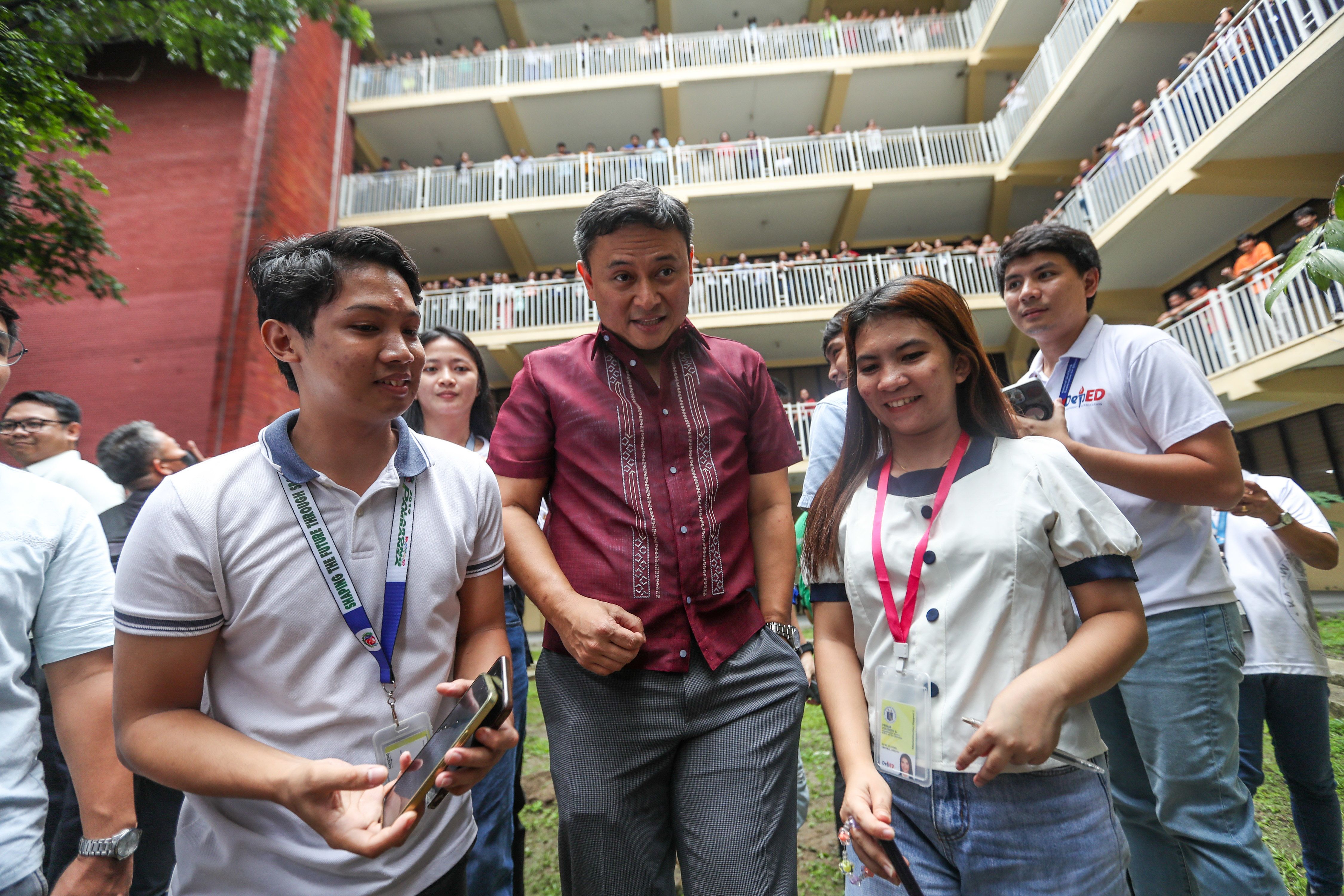 Recently appointed Education Secretary Sen. Sonny Angara interacts with employees and guests during the Department of Education Turnover Ceremony at the  DepEd Central Office grounds in Pasig City on July 18, 2024. Jonathan Cellona, ABS-CBN News/File