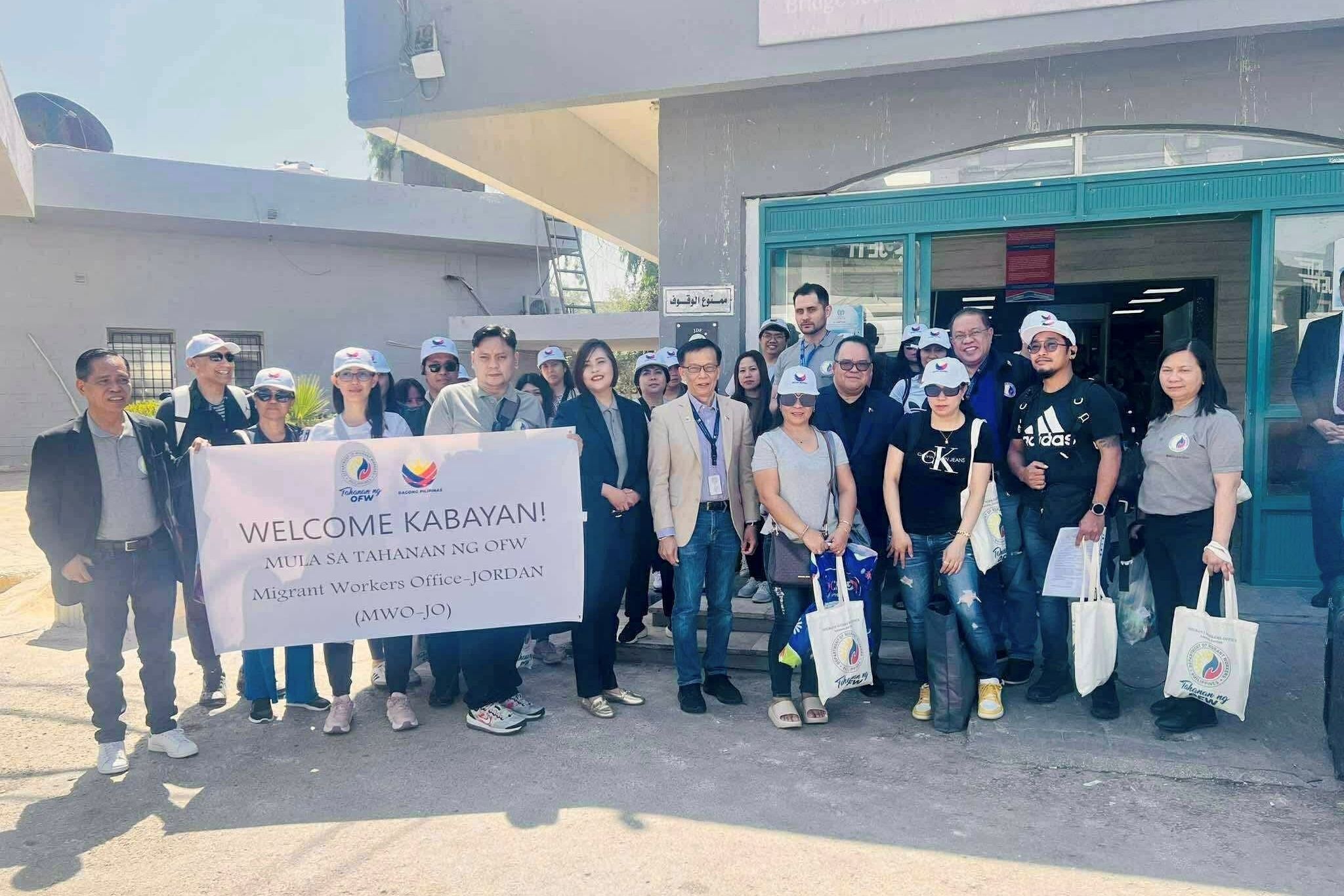 DWM Sec. Hans Leo Cacdac and Philippine Ambassador to Jordan Wilfredo C. Santos assist 26 OFWs and one Filipina tourist who availed of voluntary repatriation. Photo courtesy of the DMW