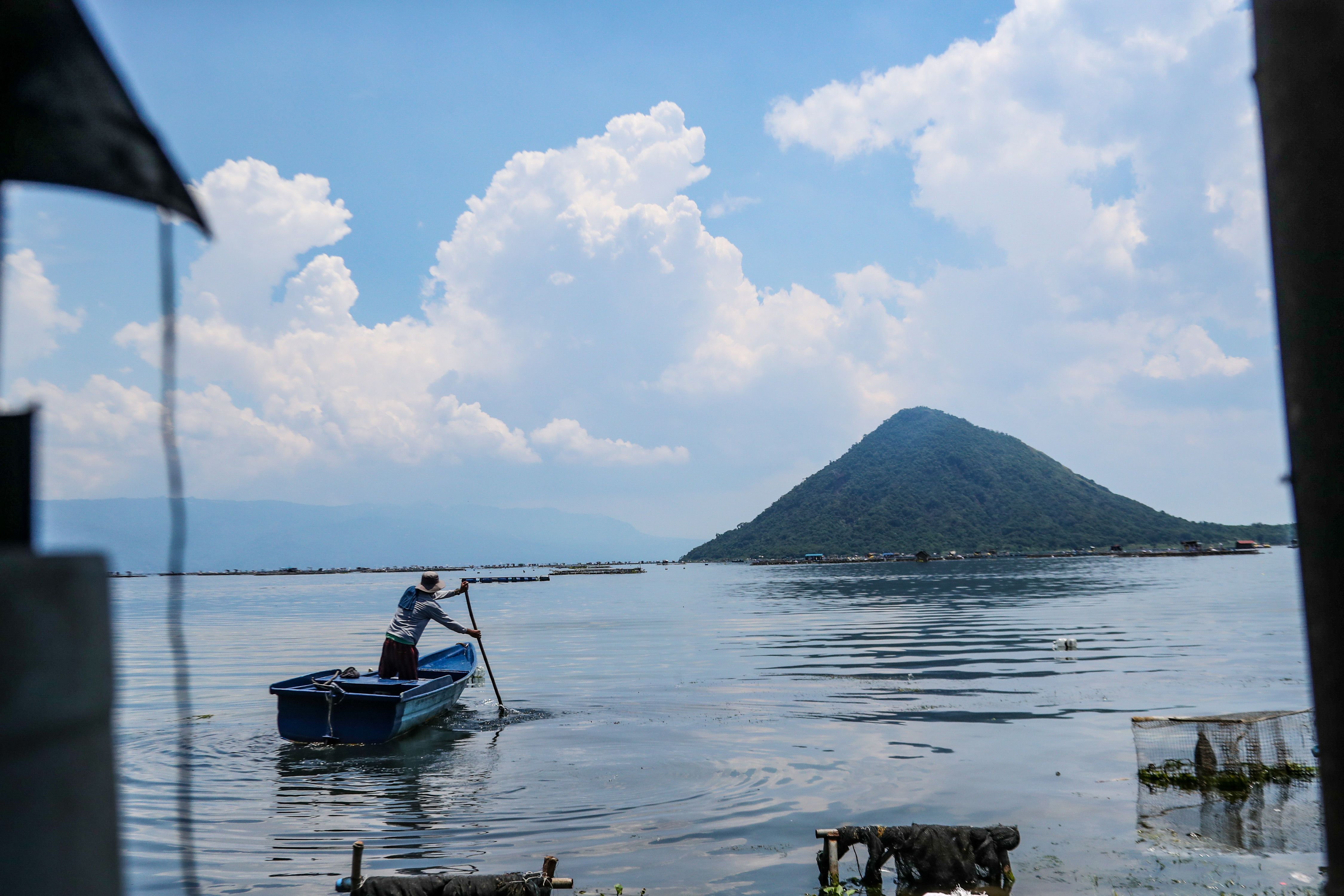 People residing in Laurel, town surrounding the Taal Volcano in Batangas, go about their chores a day after volcanic smog clears from Volcano island in Taal Batangas on August 20, 2024. Jonathan Cellona, ABS-CBN News/File