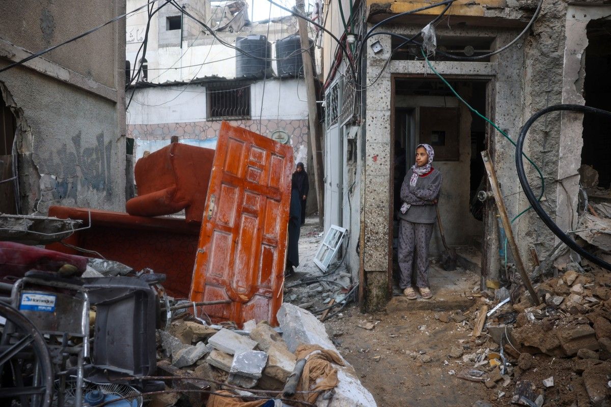 A girl stands in the doorway of a house hit by Israeli bombardment at the Bureij refugee camp in central Gaza Strip on March 25, 2025. Eyad Baba, AFP/File