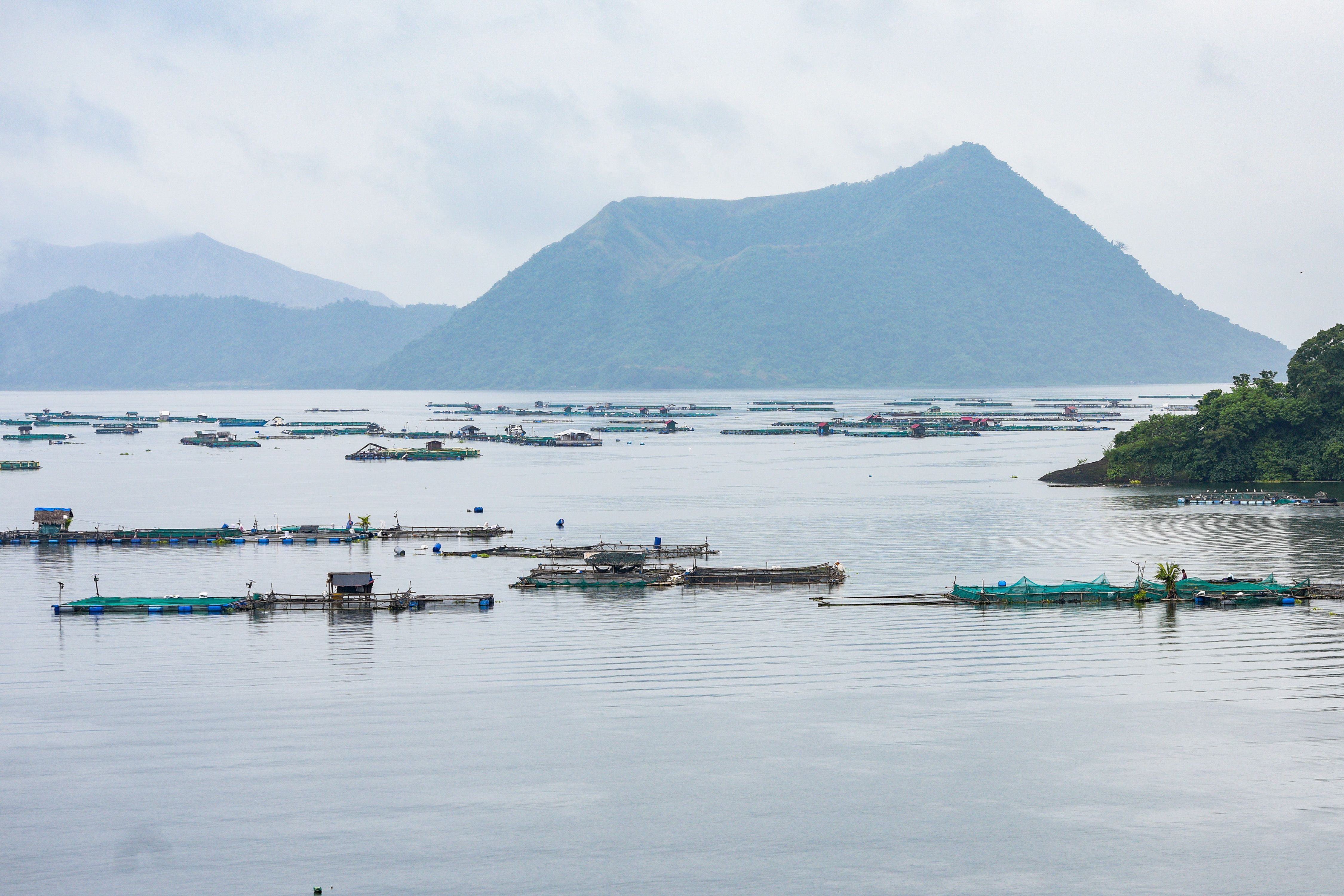 Fisherfolk return to their normal activities at the Taal lake in Talisay, Batangas on Saturday, September 23, 2023, as the volcanic smog from Taal volcano clears due to the rains. Maria Tan, ABS-CBN News