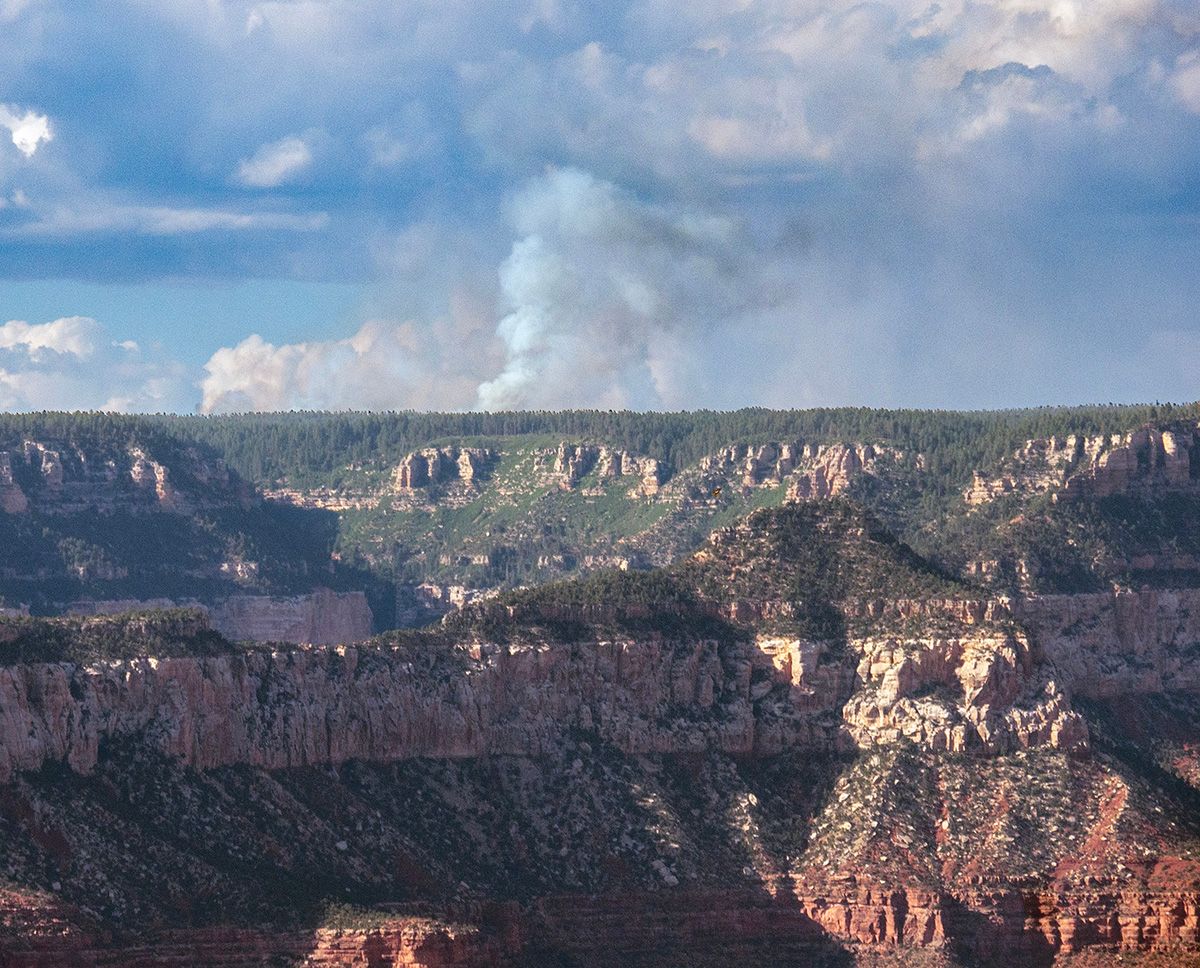 In this July 9, 2025 photo posted by the US National Park Service, smoke is seen from the Dragon Bravo Fire, a lightning-caused wildfire burning on the North Rim of Grand Canyon National Park. Grand Canyon National Park Facebook page