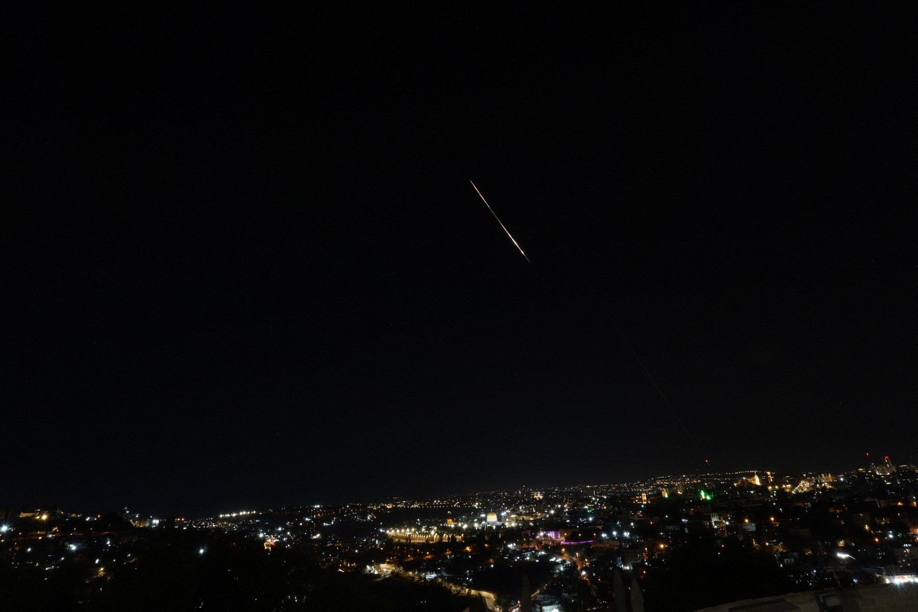 This picture shows a rocket trail from Israel's Iron Dome missile-defense system batteries fired to intercept rockets fired from Iran above Jerusalem on June 13, 2025. Ahmad Gharabli, AFP/File
