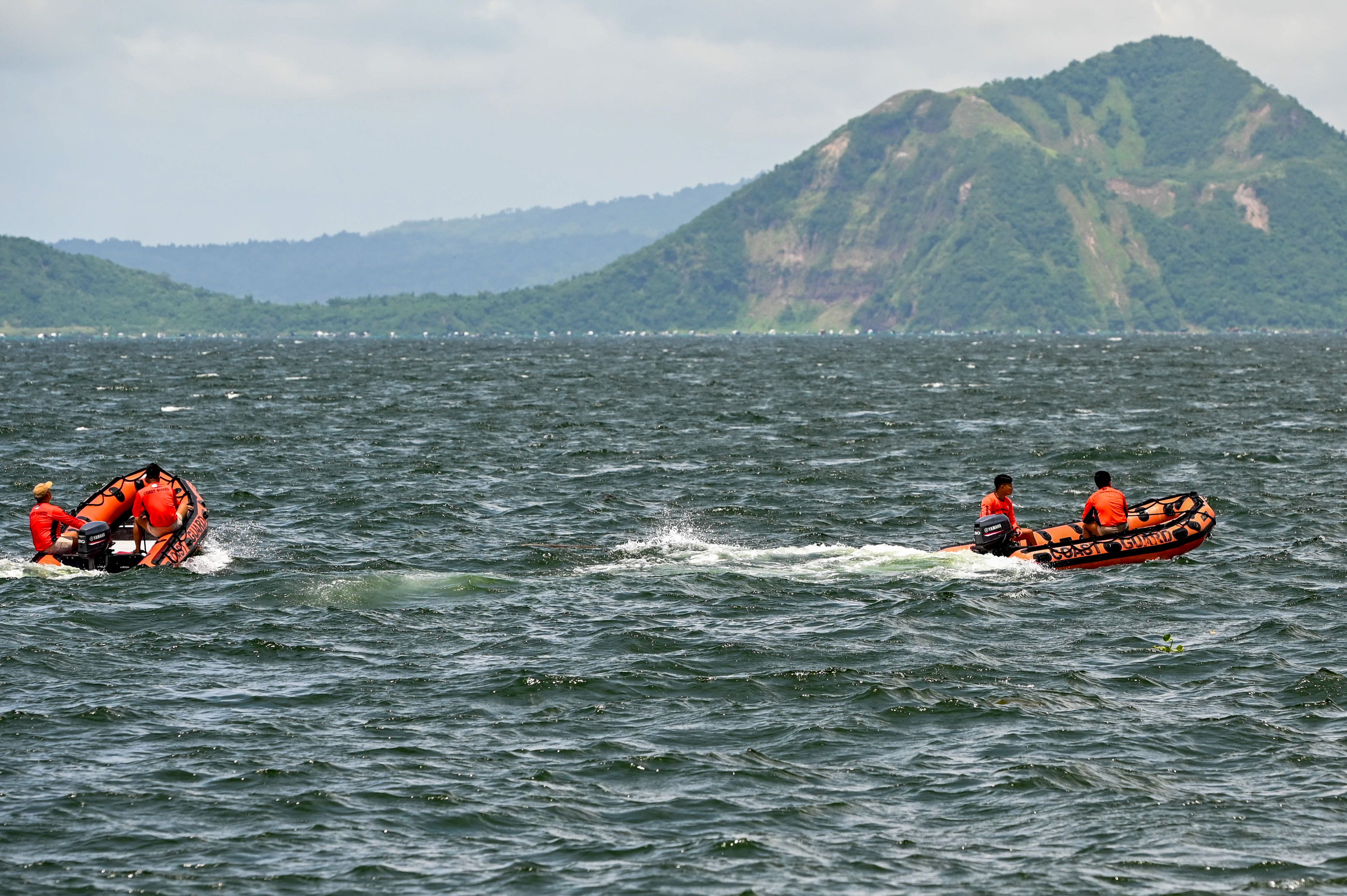 Members of the Philippine Coast Guard navigate the waters of Taal Lake in Talisay, Batangas, on Thursday, July 10, 2025, as the multi-agency search continues for the missing 'sabungeros.' Maria Tan, ABS-CBN News