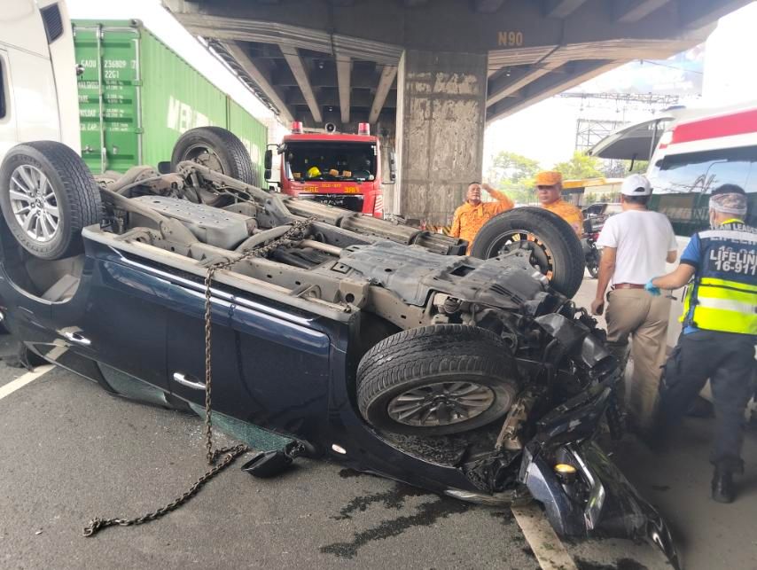 An SUV crashed into a guardrail and flipped over the southbound lane of SLEX, causing it to hit another SUV and a passenger bus. Handout/PNP-HPG