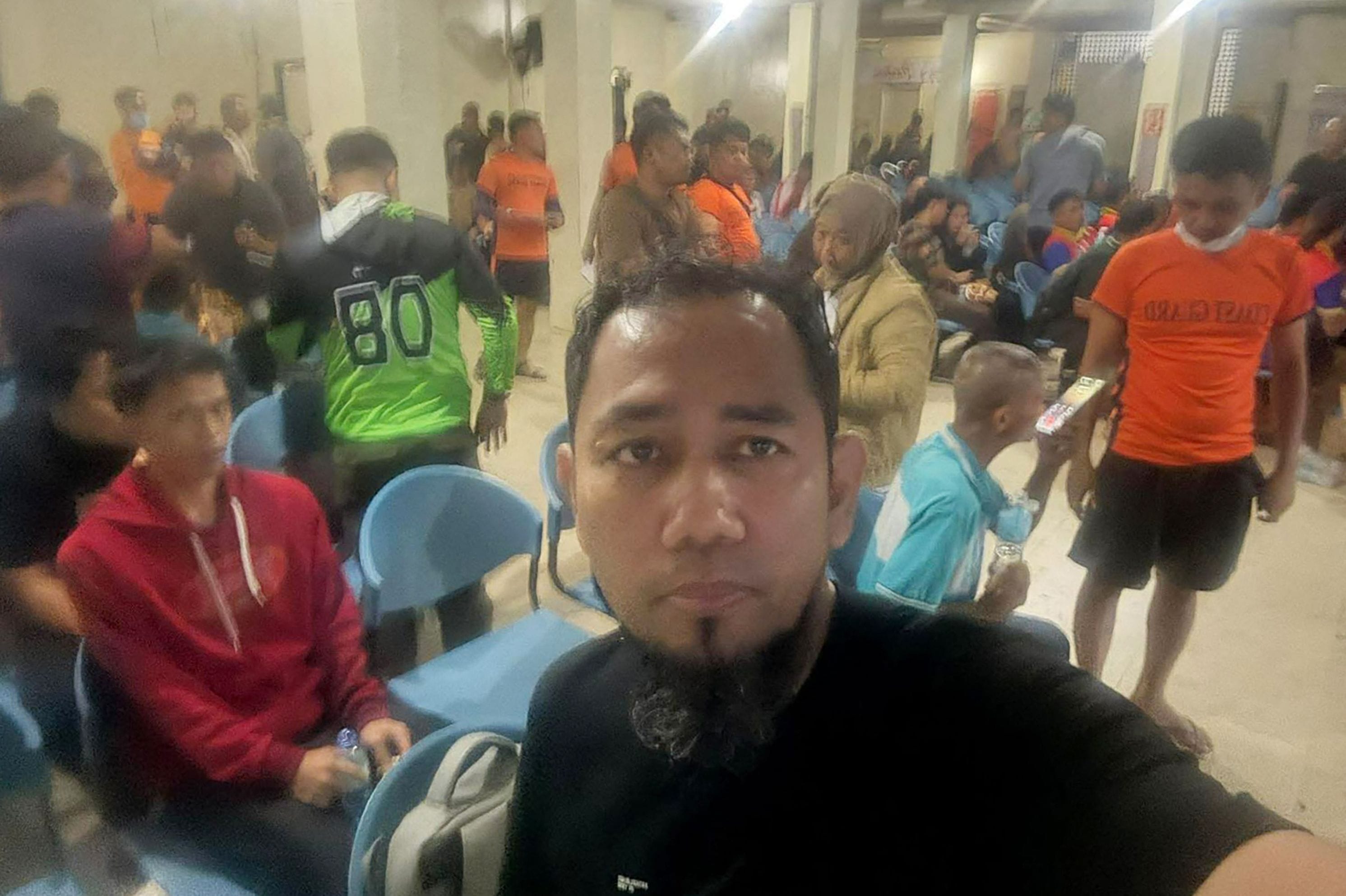 This handout photo taken and received on January 26, 2026 courtesy of Aquino Sajili, an attorney based in Zamboanga City in Mindanao, shows Sajili taking a selfie showing other survivors of the MV Trisha Kerstin 3 ferry, which sank in waters off Basilan province, following their rescue at a port in Isabela, Basilan province. Handout/Aquino Sajili via AFP