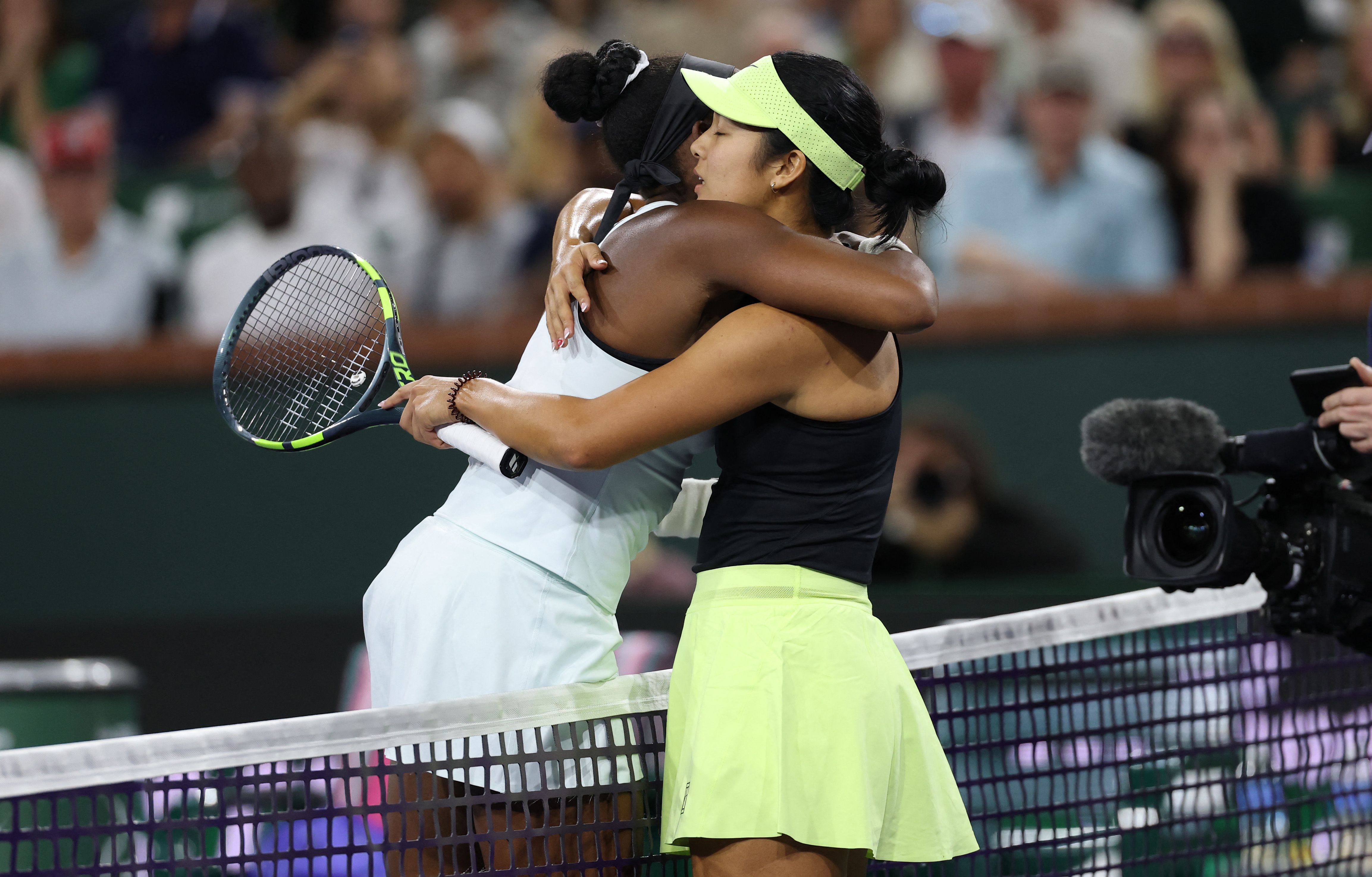 Coco Gauff of the United States at the net with Alexandra Eala of the Philippines after she has retired with an arm injury from their third round match of the BNP Paribas Open at Indian Wells Tennis Garden on March 08, 2026 in Indian Wells, California. Clive Brunskill, Getty Images/AFP