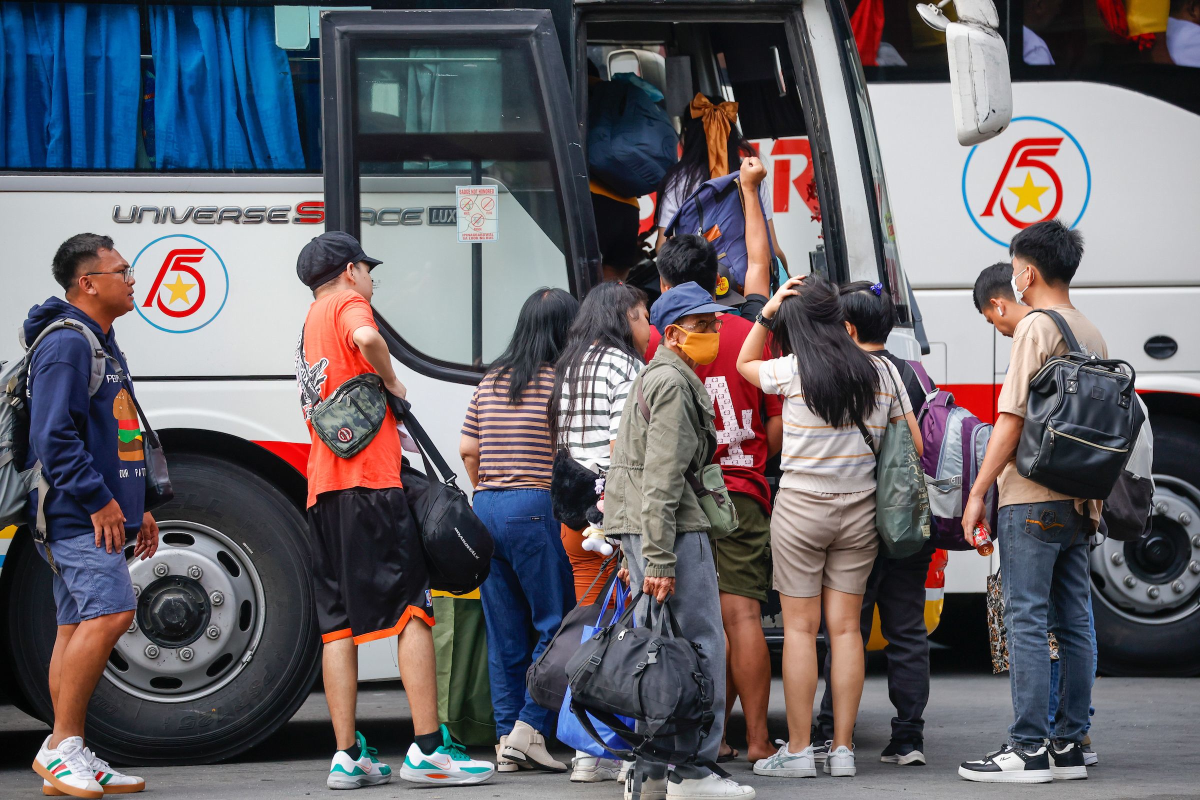 Passengers arrive at a bus terminal in Cubao, Quezon City to take their early trip for the Holy Week break on April 11, 2025. Maria Tan, ABS-CBN News/File