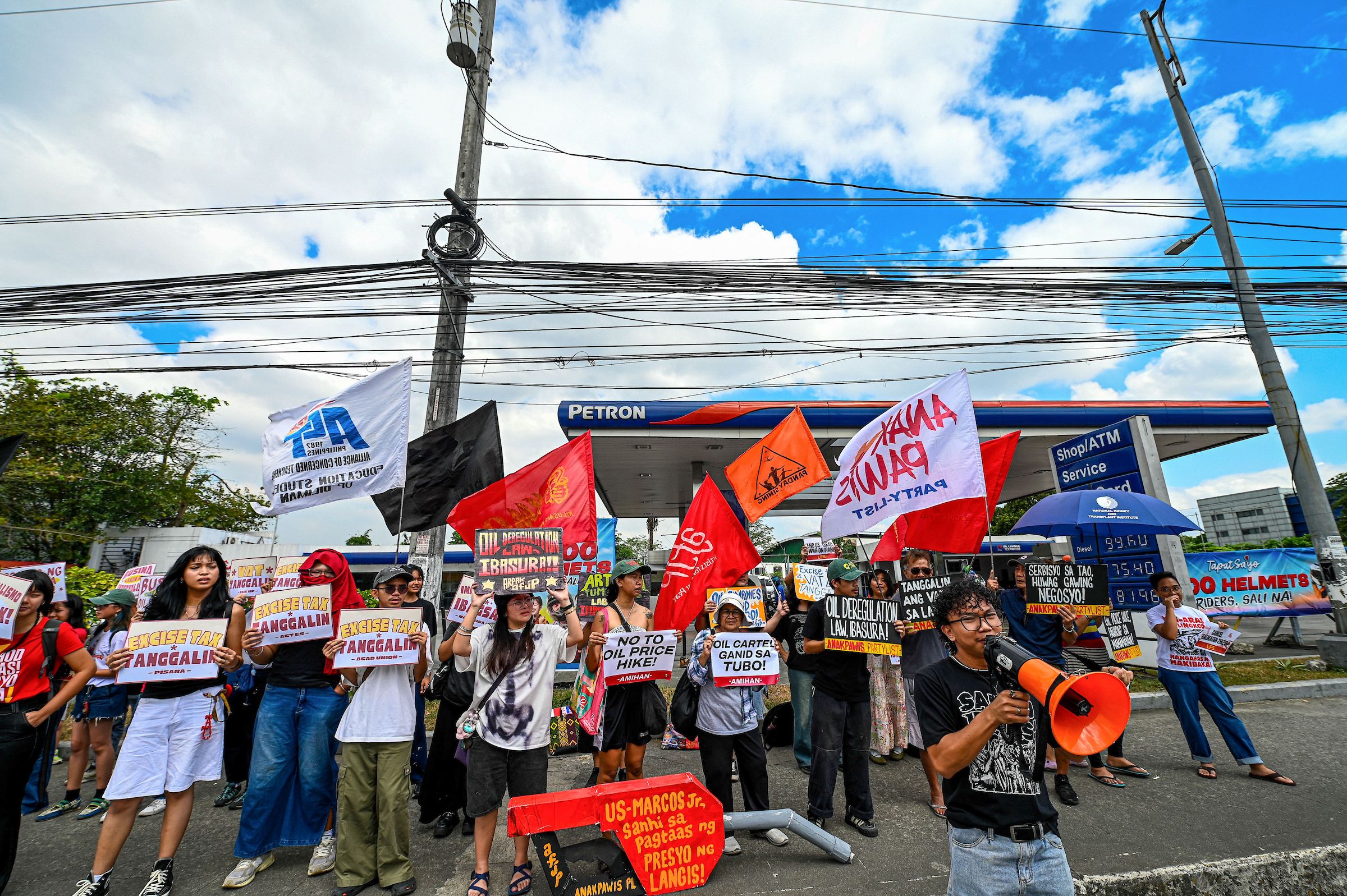 Progressive groups hold a protest on the second day of a transport strike at a gasoline station in Philcoa, Quezon City, calling for government action on rising fuel prices and policies affecting drivers. Maria Tan, ABS-CBN News