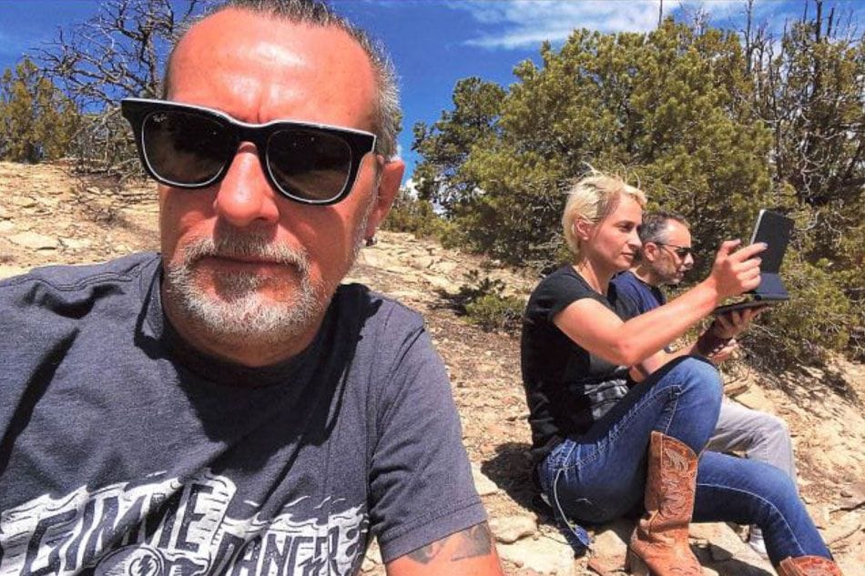 This undated handout image released by Dordick Law Corporation on November 10, 2021 shows chief lighting technician Serge Svetnoy (L) taking a 'selfie' with cinematographer Halyna Hutchins (C) and director Joel Souza on the set of the movie 